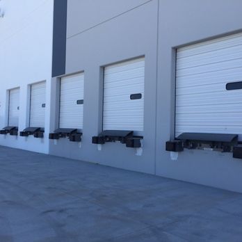 Row of new commercial loading dock doors installed on a warehouse